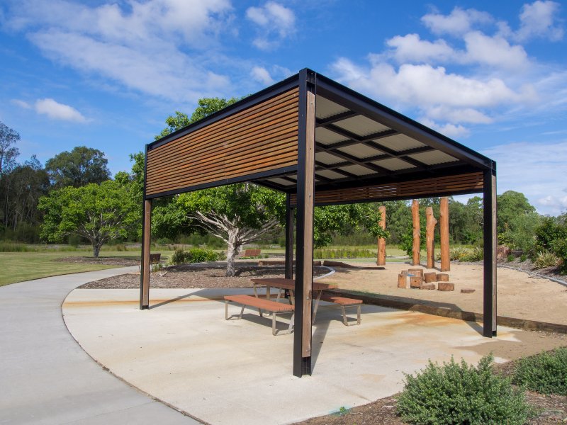 wooden and black pergola with picnic bench